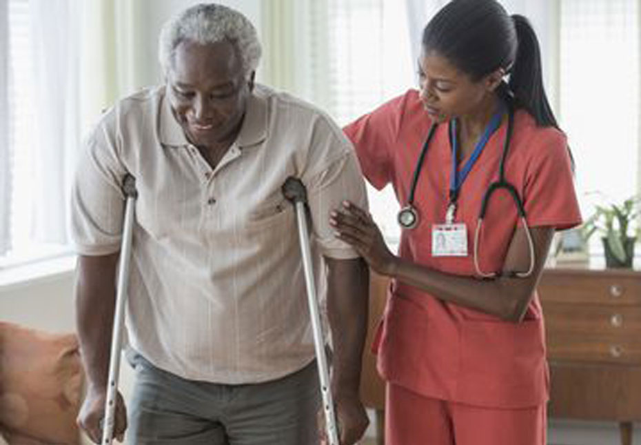 Nurse assisting patient on crutches